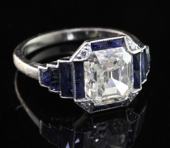 An Art Deco platinum single stone diamond and sapphire octagonal dress ring, size M.